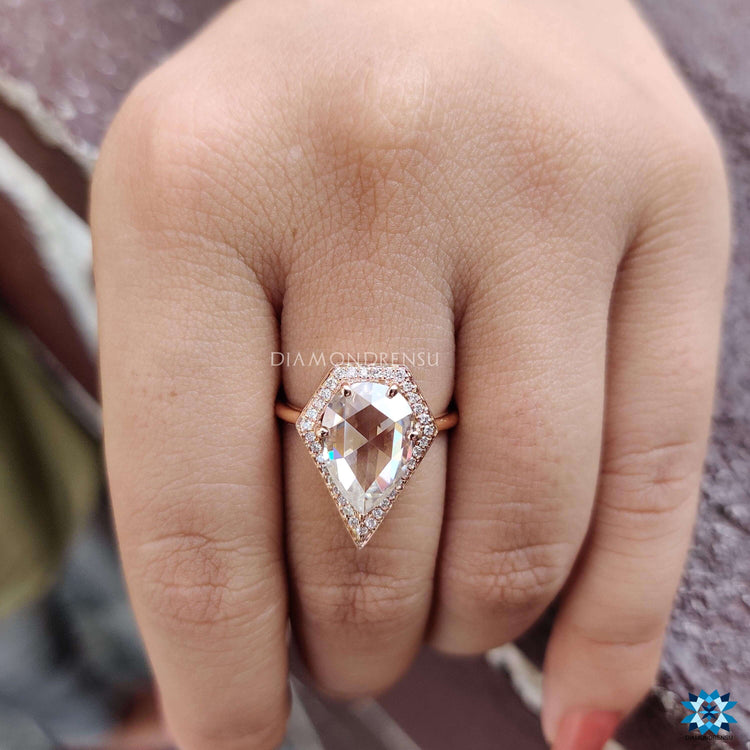 Halo engagement ring with pear rose cut center.