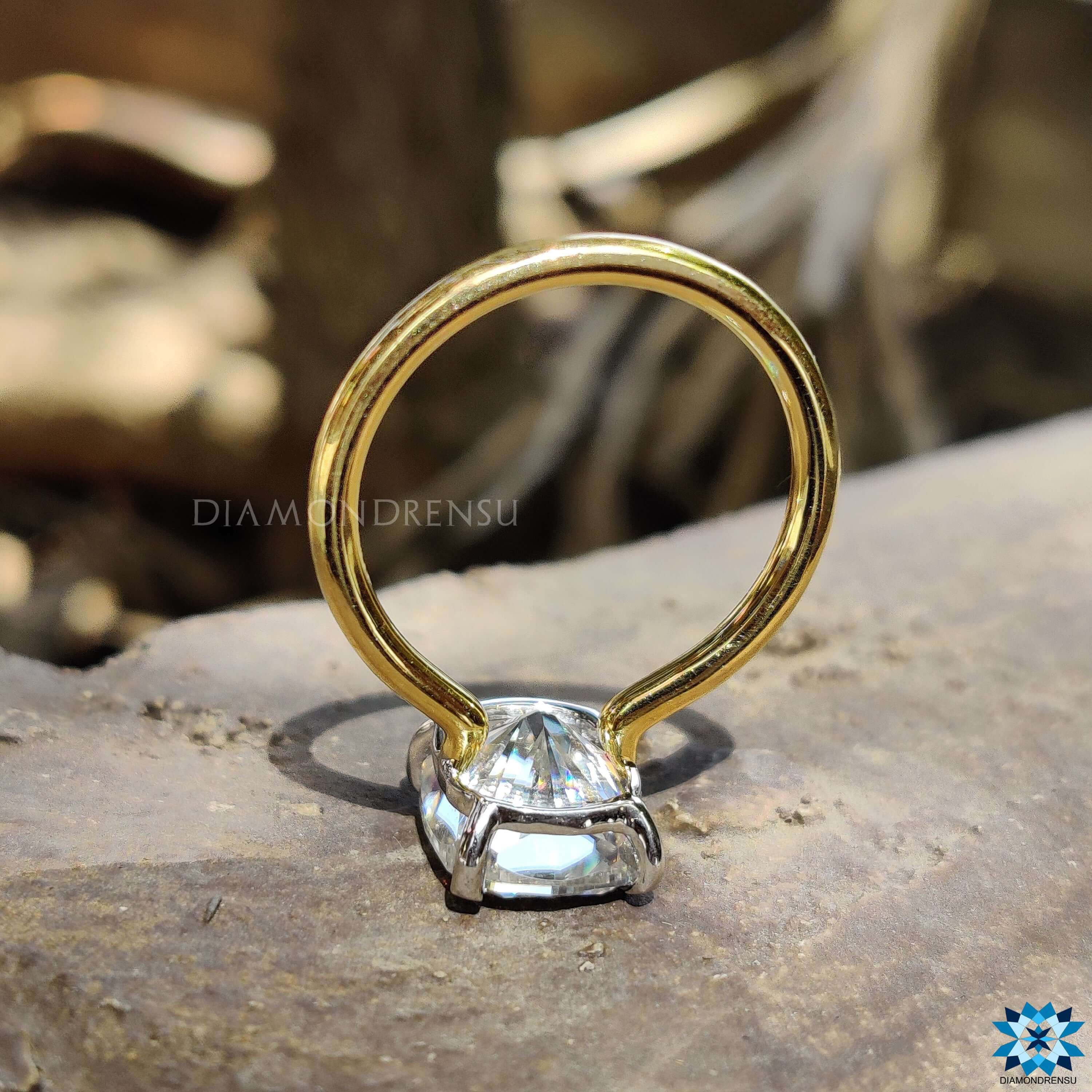 Claw prong setting on elongated cushion moissanite ring.