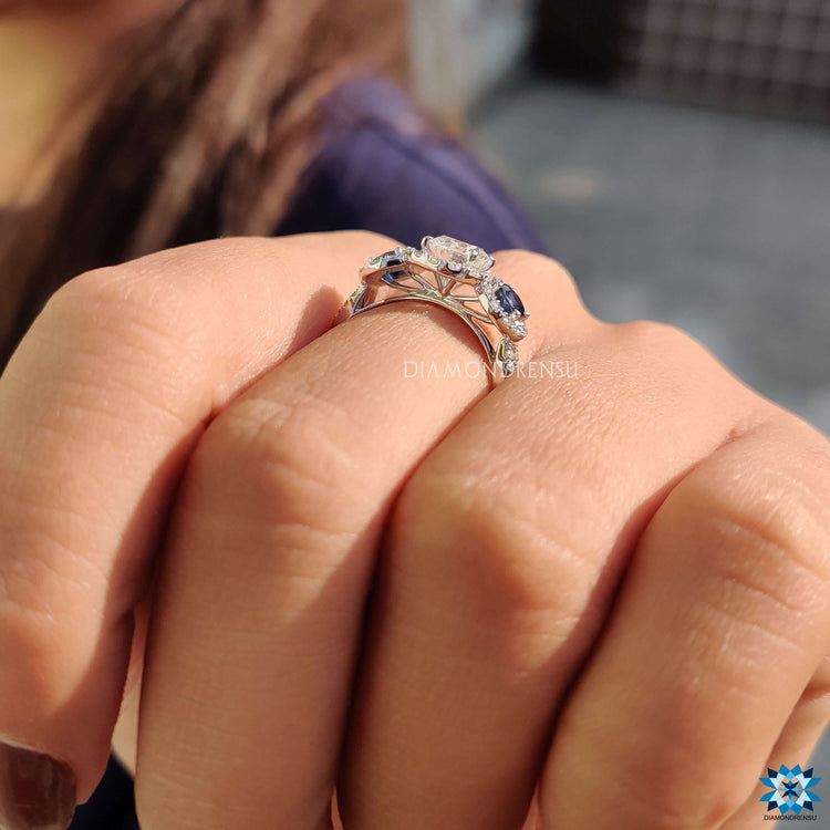 Moissanite halo ring with natural sapphire on twisted band.