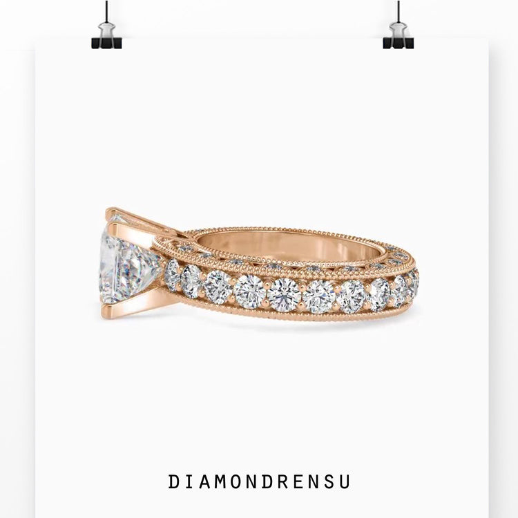 Side stone engagement ring with lab grown princess cut diamond.