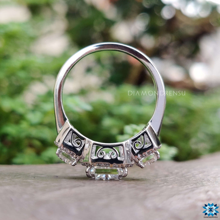 White gold ring featuring radiant cut center and side stones.