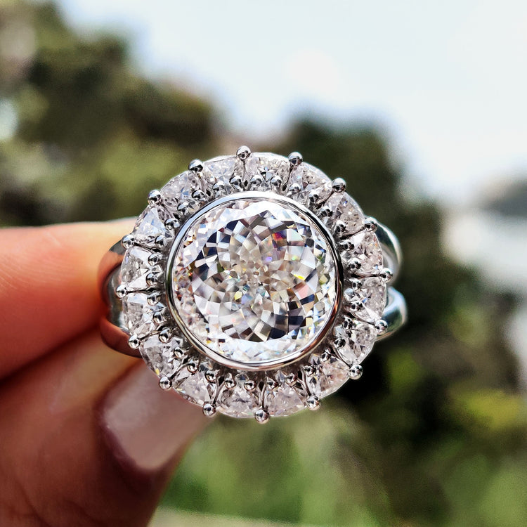 Vintage engagement ring with Portuguese cut moissanite and split shank band.