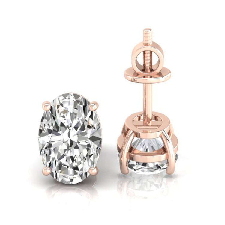 Gold stud earrings with oval cut diamond in basket setting.