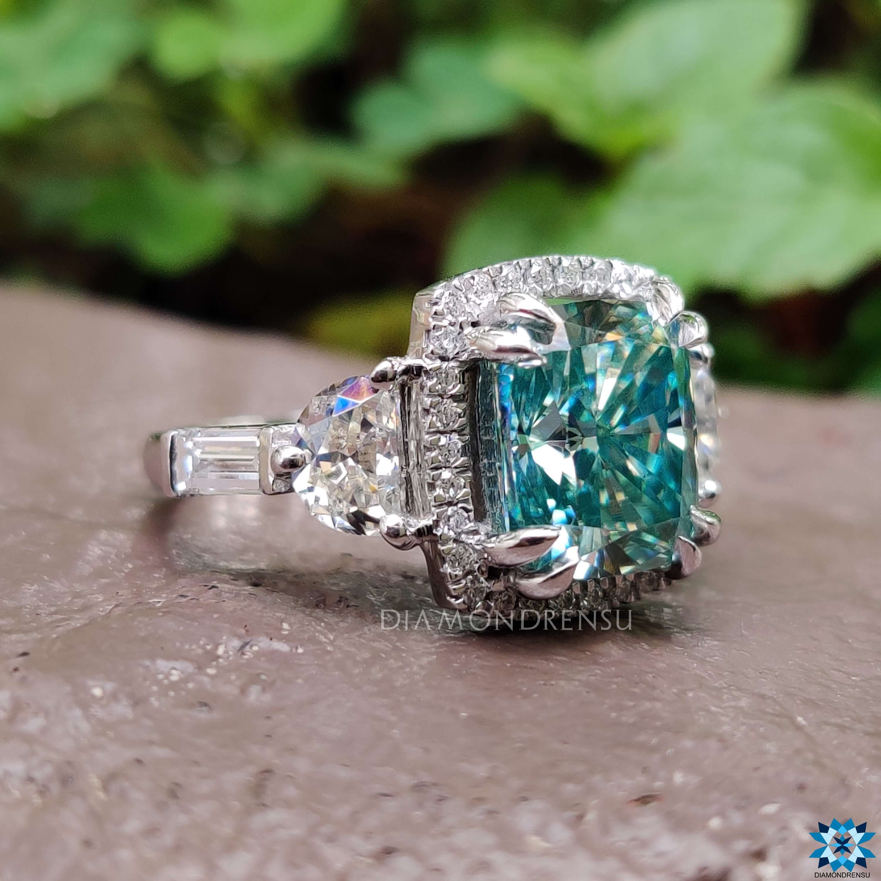 Double claw prong ring with five moissanite stones in white gold.