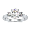 Three stone ring with oval centre diamond and trapezium sides.