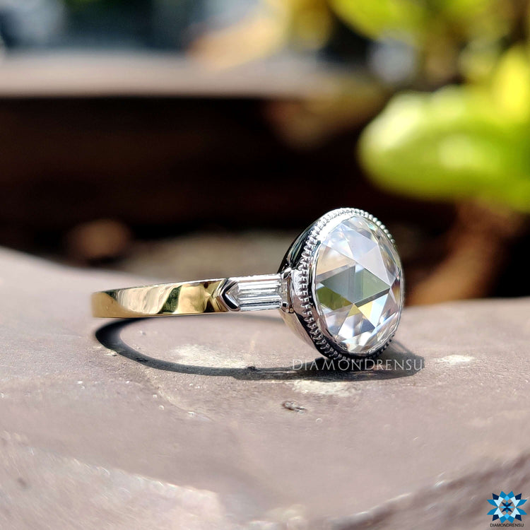 Yellow and white gold ring with milgrain bezel setting.