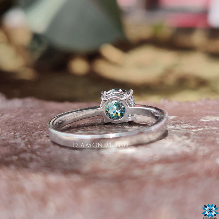Cyan blue moissanite ring in white gold.