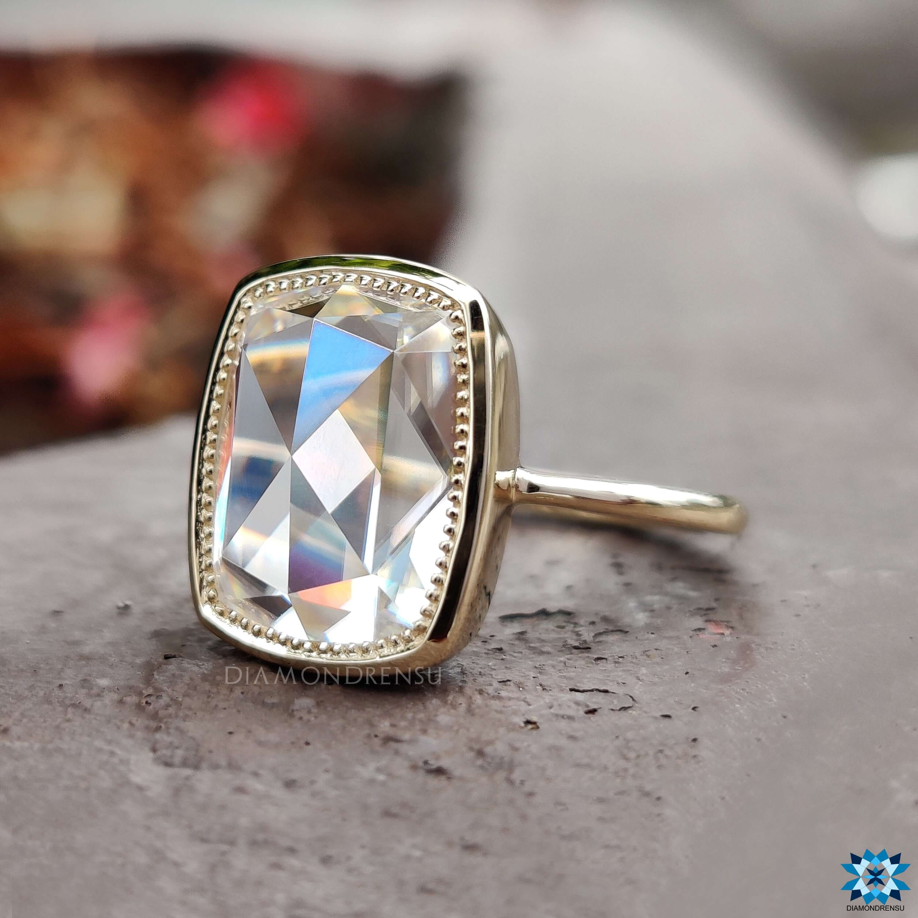 Bezel set moissanite ring in yellow gold.