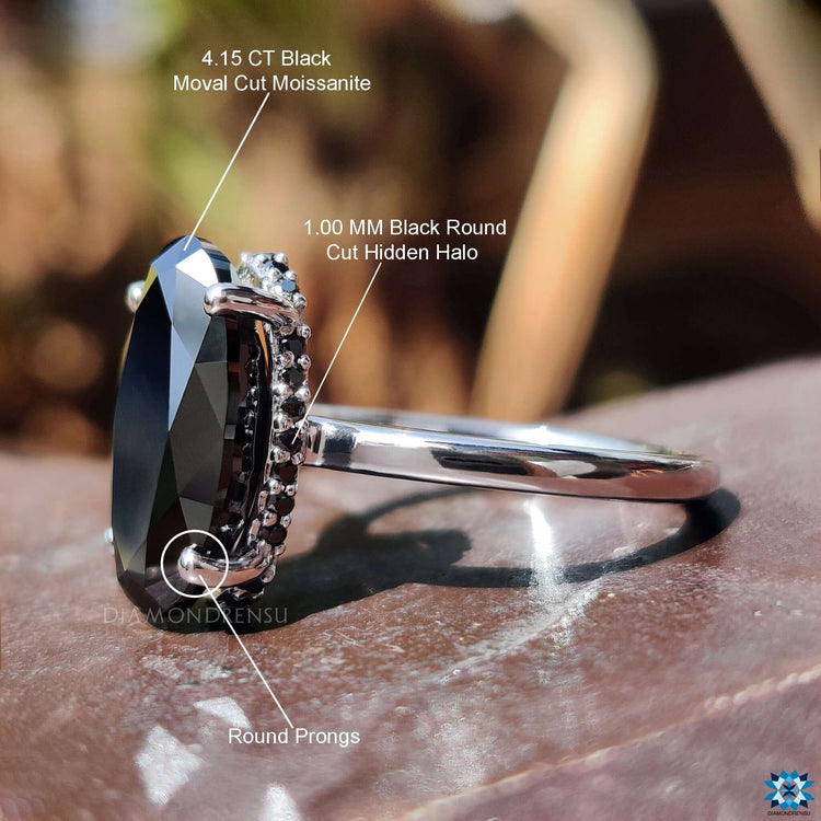 Custom engagement ring with moval cut center stone.