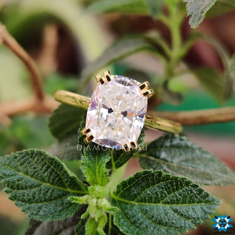 Cushion moissanite ring with tab prongs.