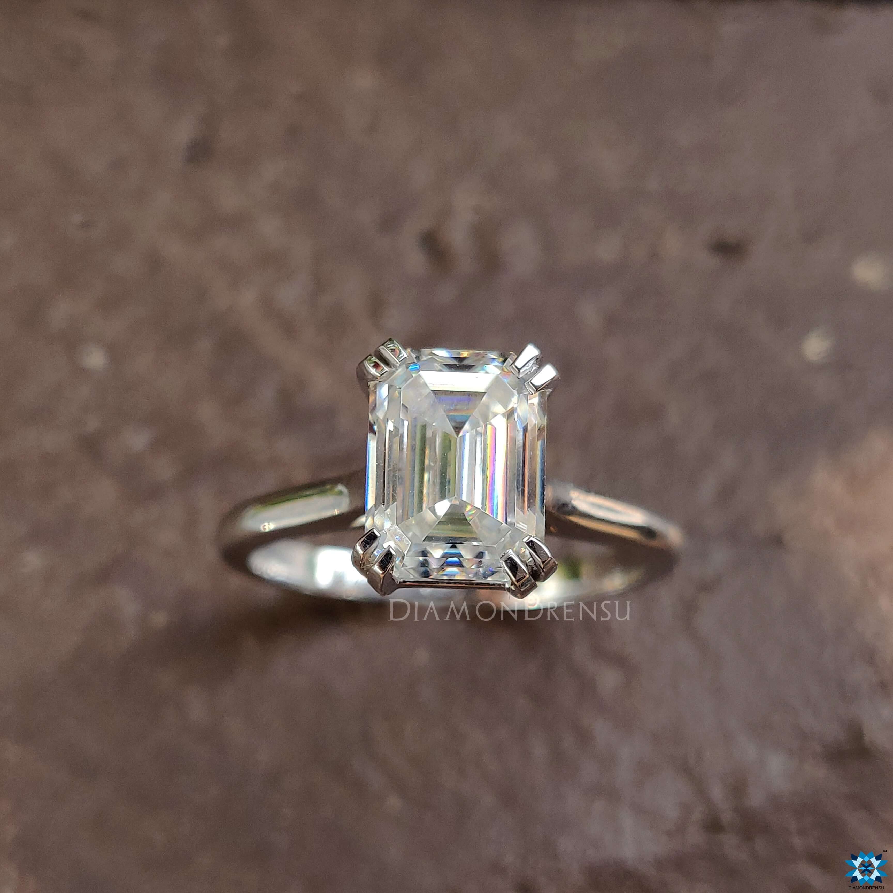 Double prong emerald cut moissanite ring.