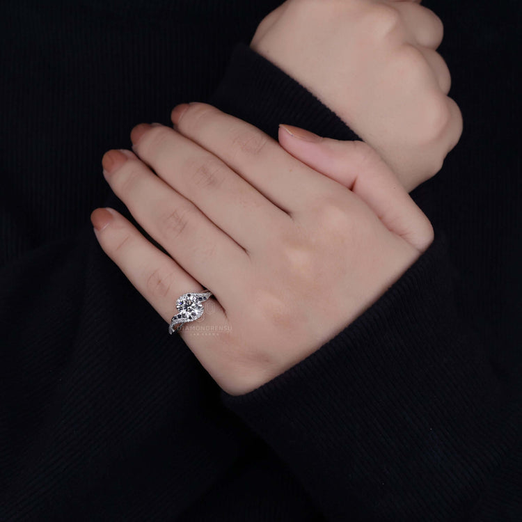 White gold engagement ring with a pave ring diamond.