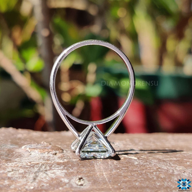 Handmade ring featuring a moissanite princess cut center stone and clean metal lines.
