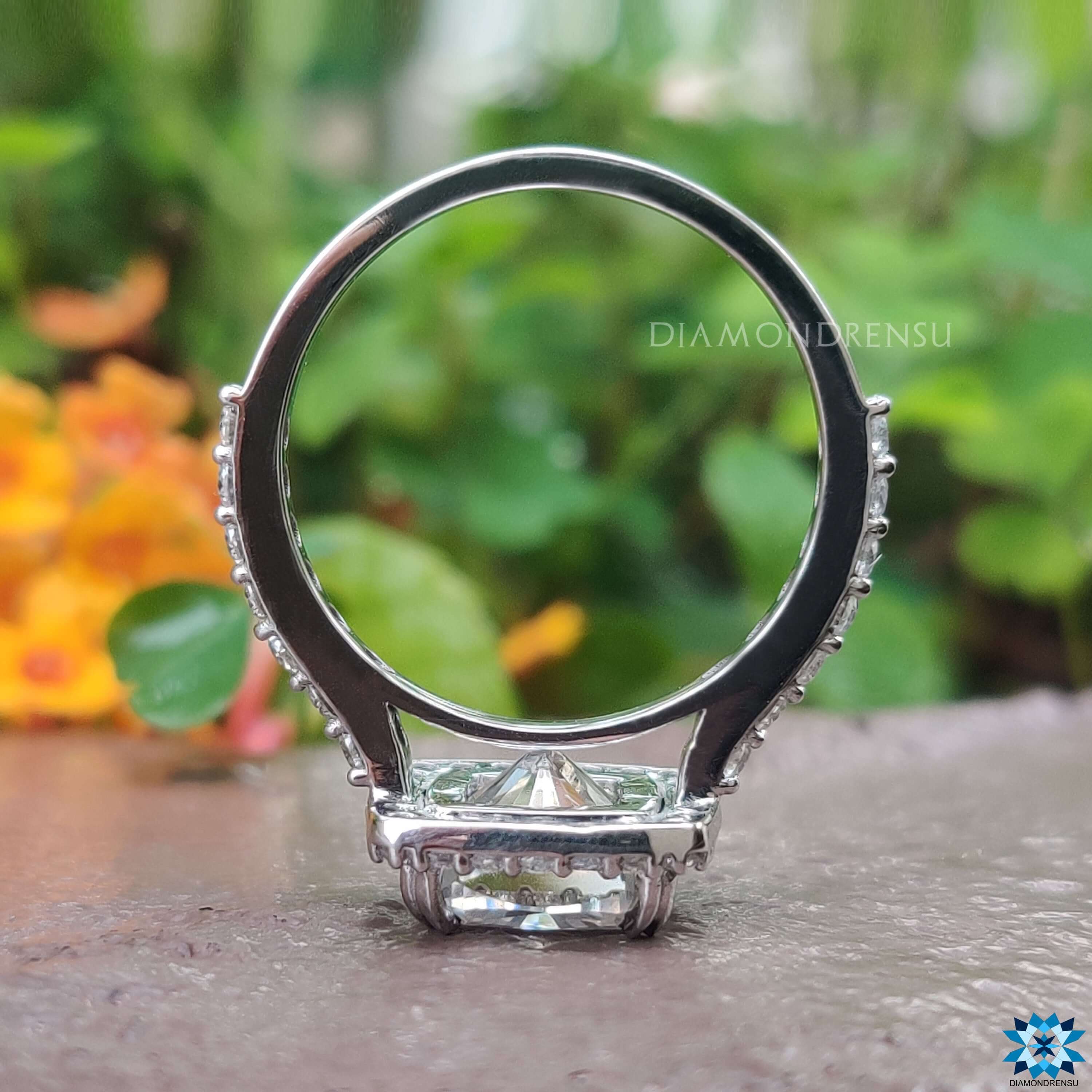 Cathedral setting ring with cushion moissanite and halo.