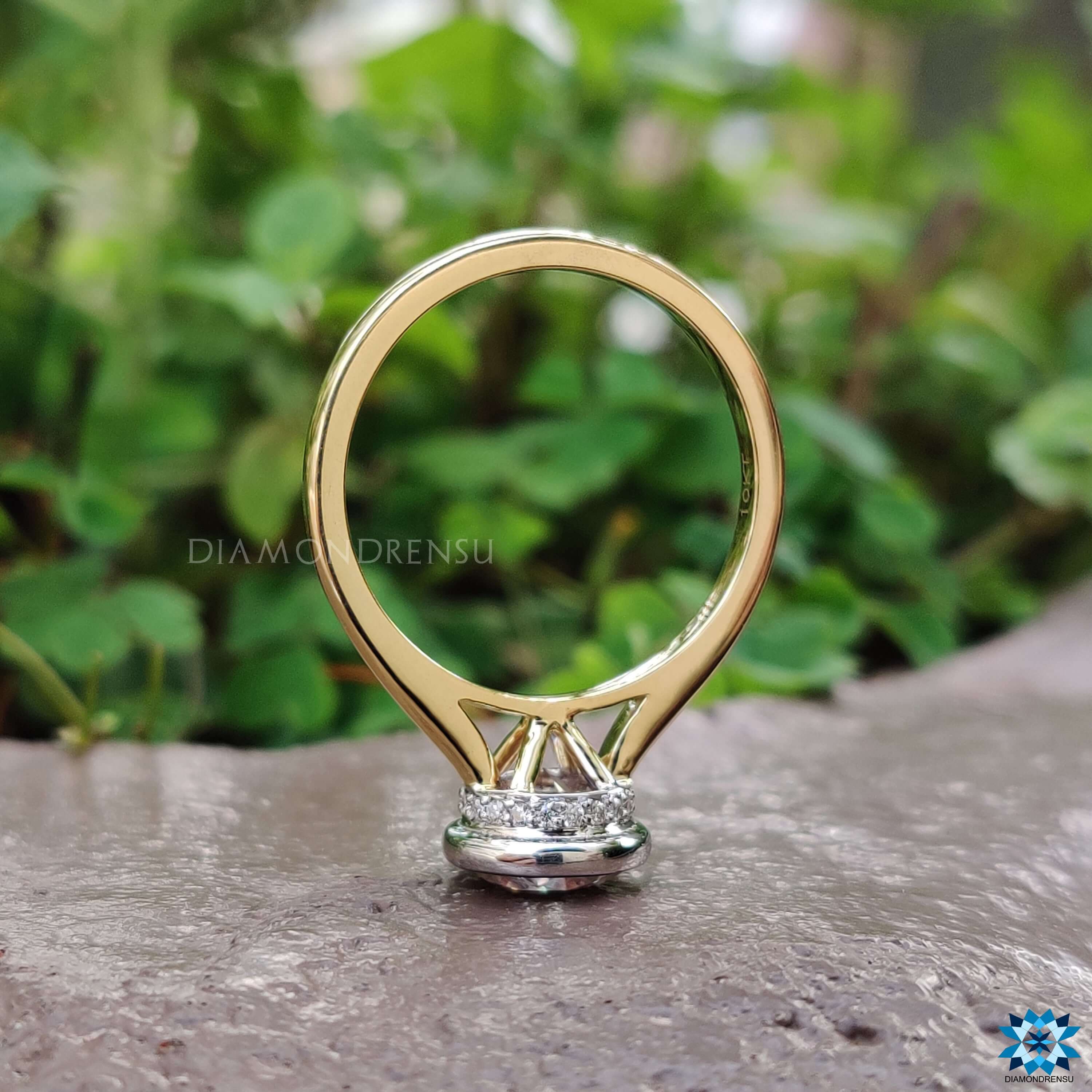 Custom bezel set engagement ring with hidden halo.