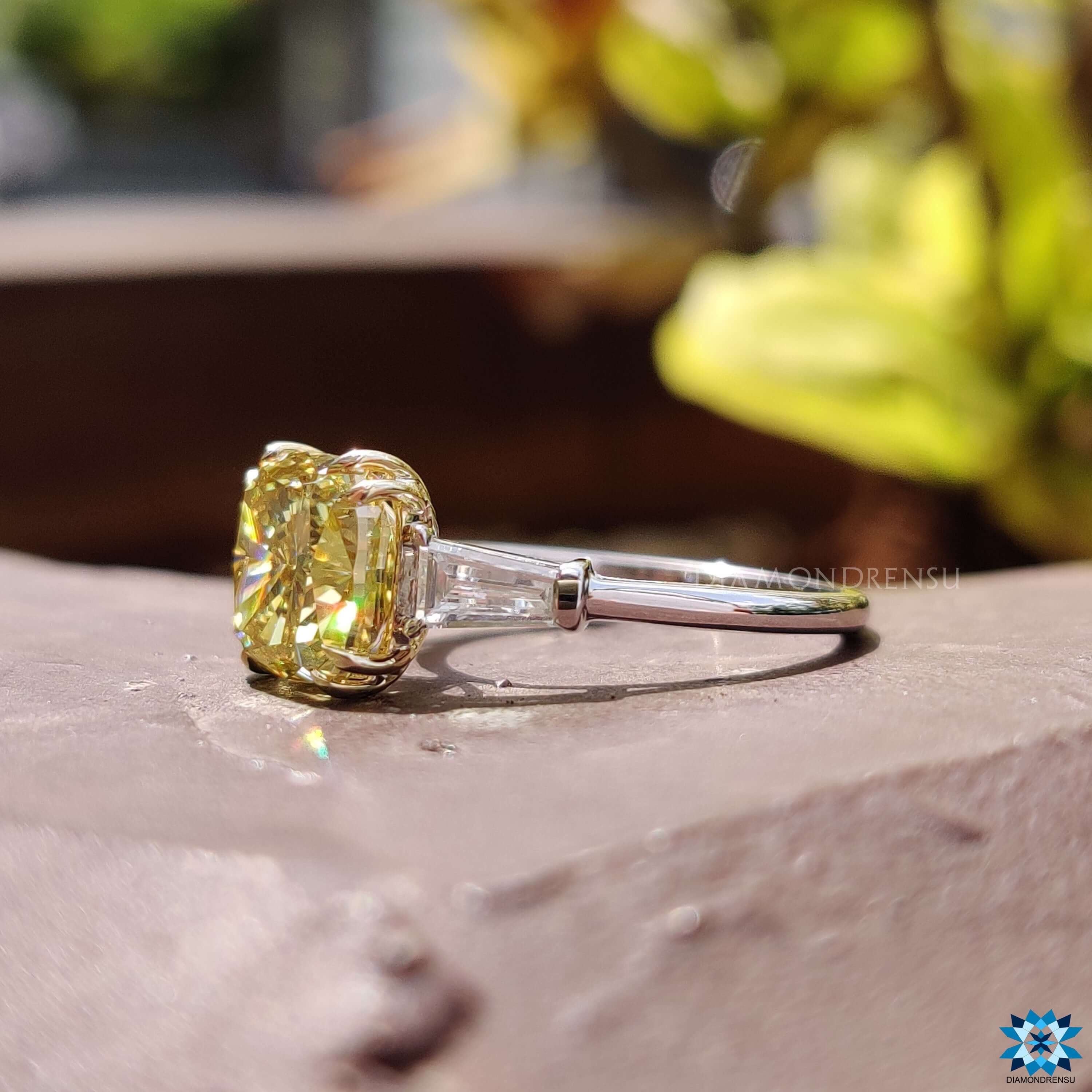 Custom engagement ring featuring cushion cut center stone.