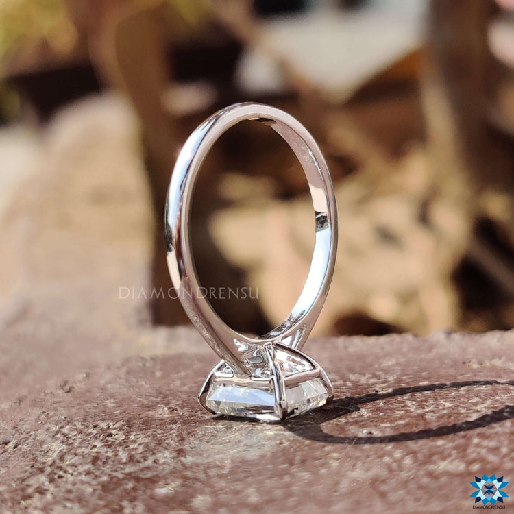 White gold engagement ring with 4 claw prong criss cut moissanite.