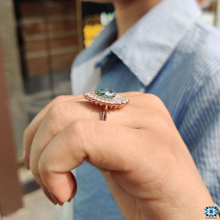 Custom engagement ring featuring cyan blue pear moissanite.