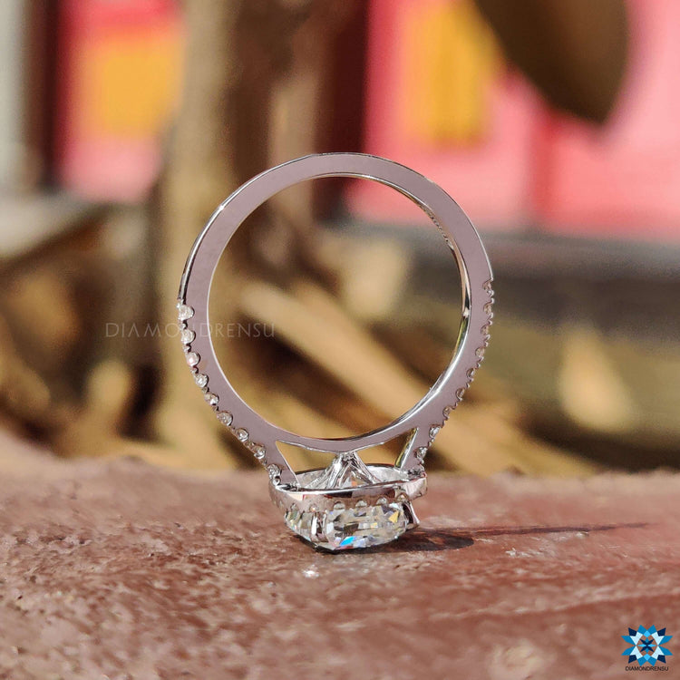 White gold moissanite ring with cushion center and brilliant halo.