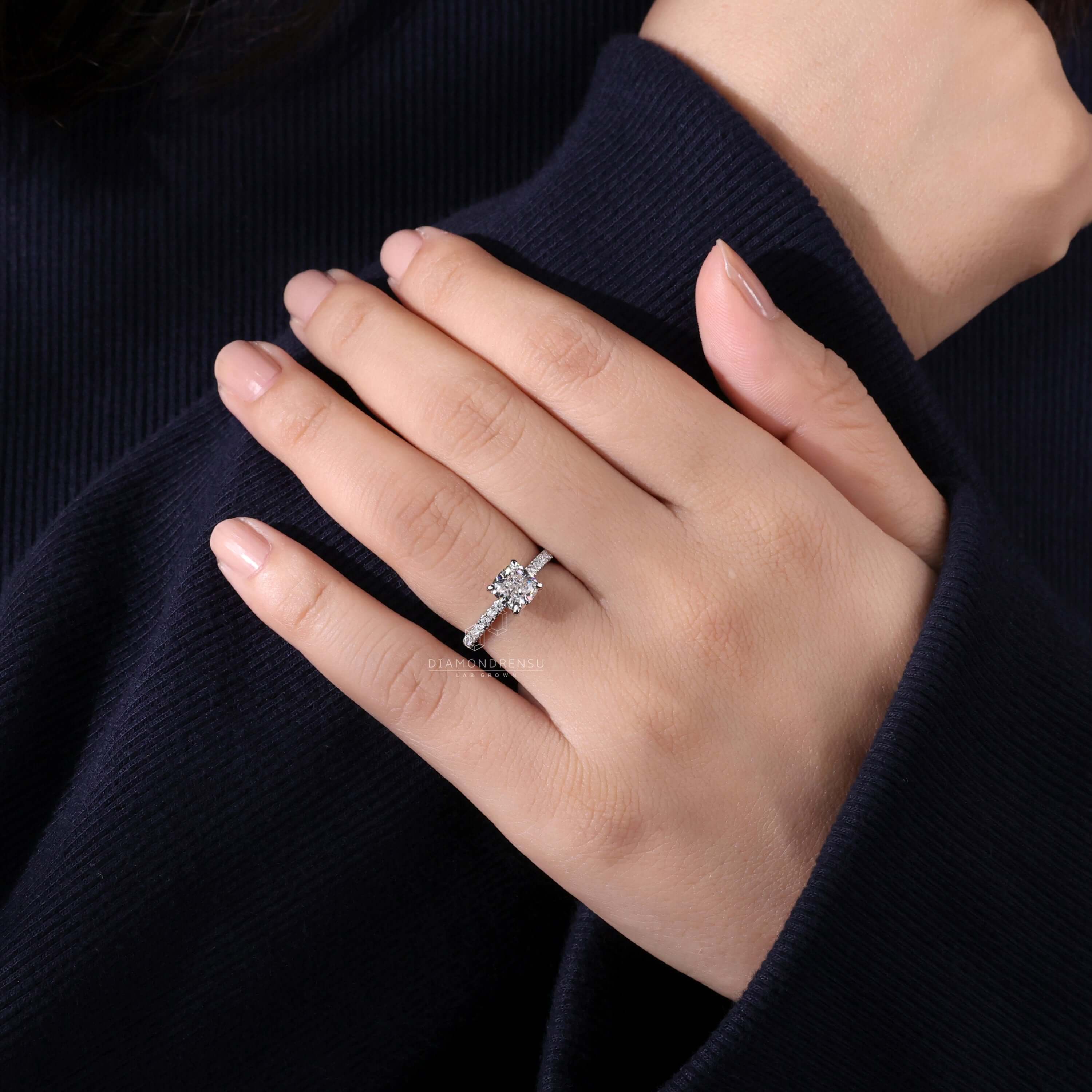 4 prong claw setting cushion cut diamond ring paired with a pave ring diamond for added sparkle.