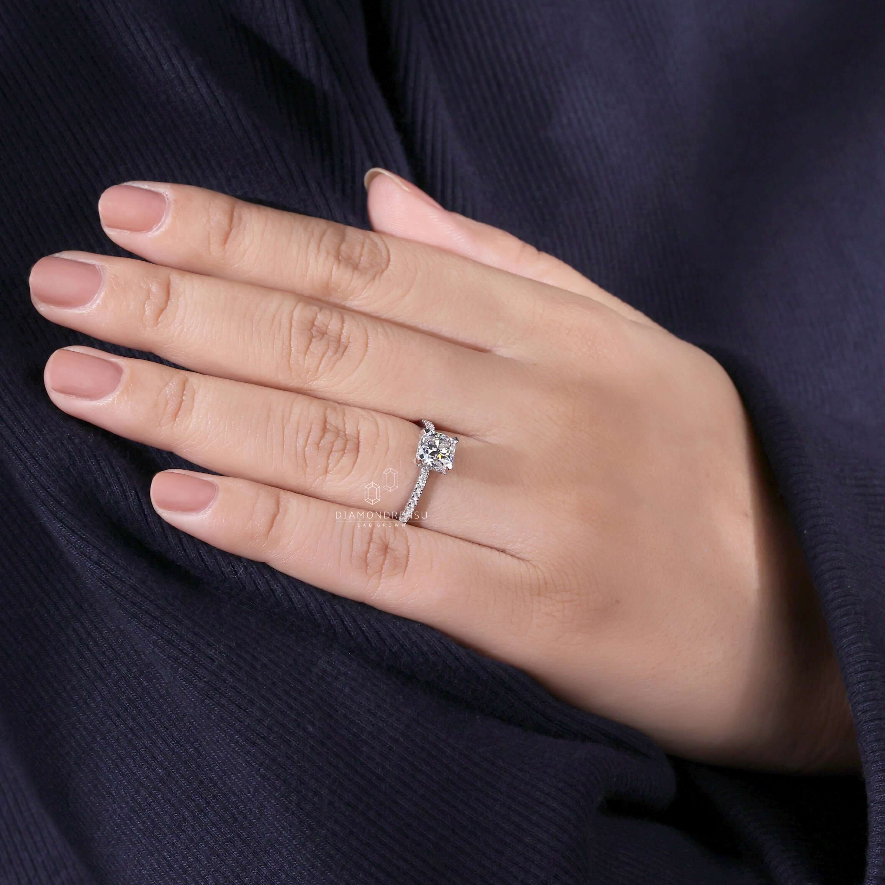 Engagement ring hidden halo design combined with tab prong detailing.
