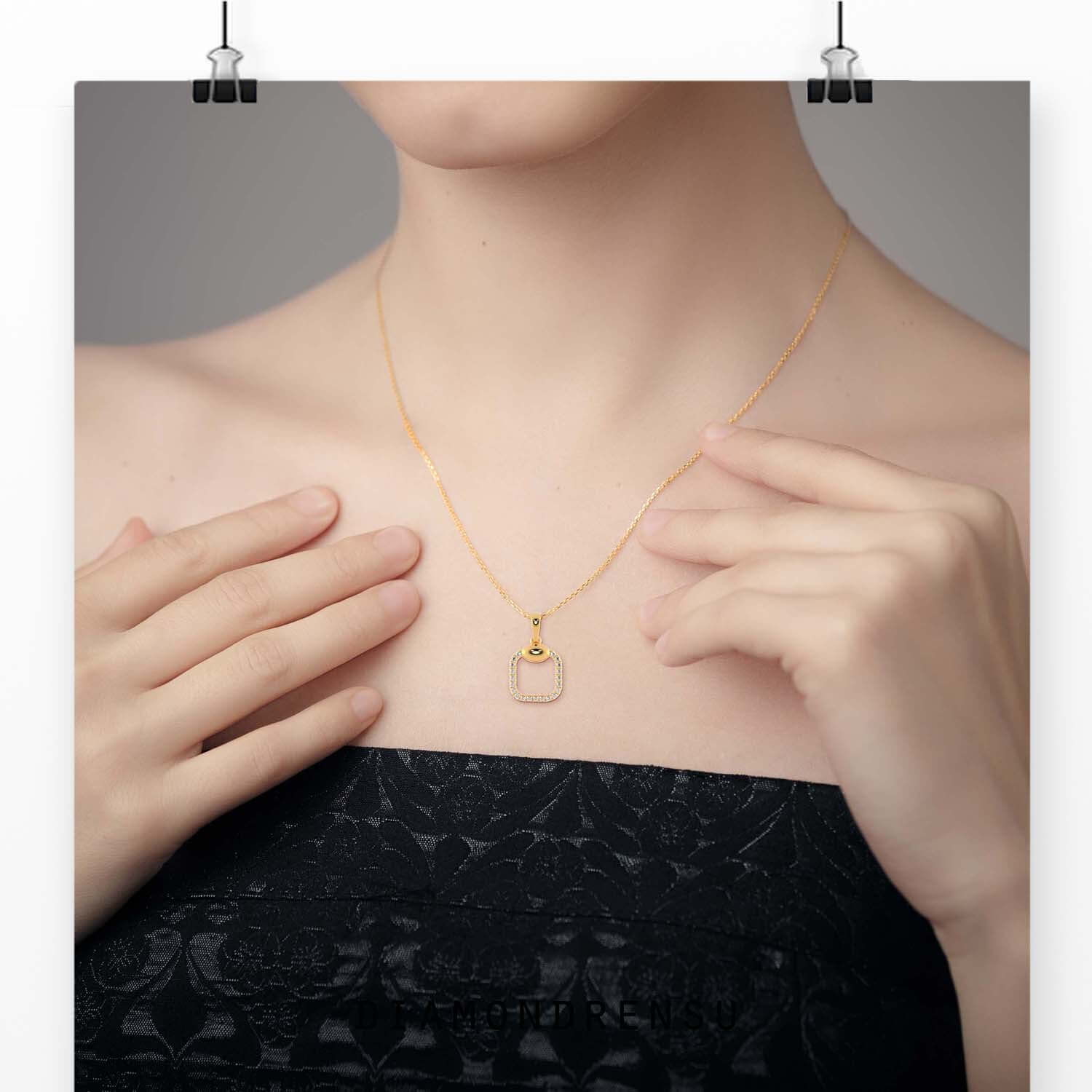 Unique round diamond pendant in gold with cushion shape halo.