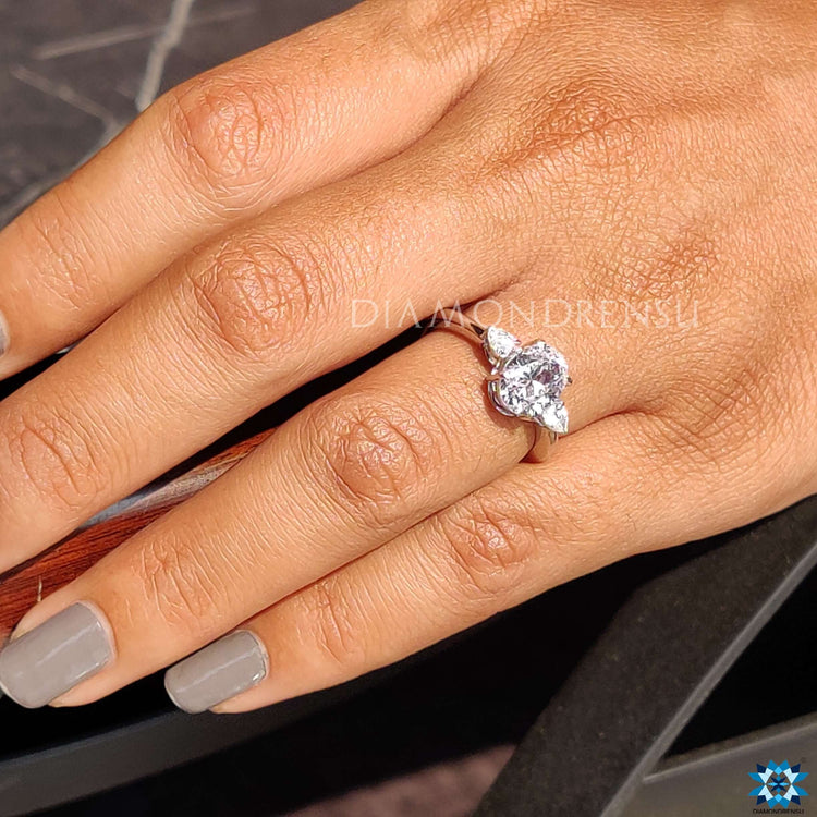 Custom ring with oval and pear moissanite stones.