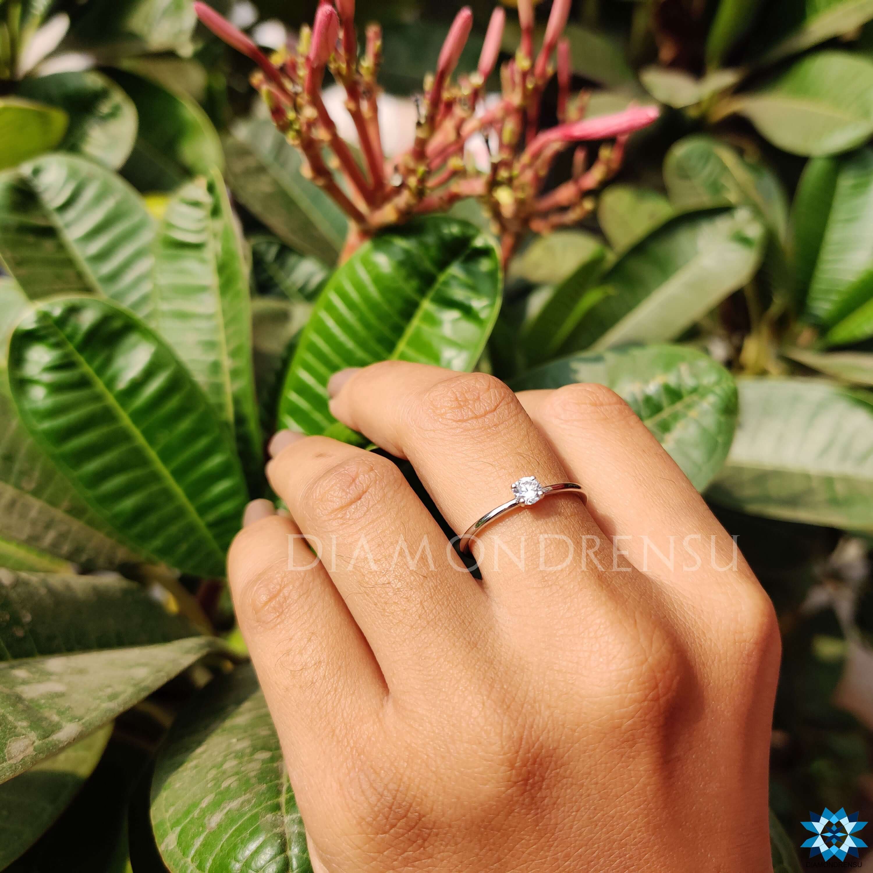 Clean design round moissanite engagement ring.