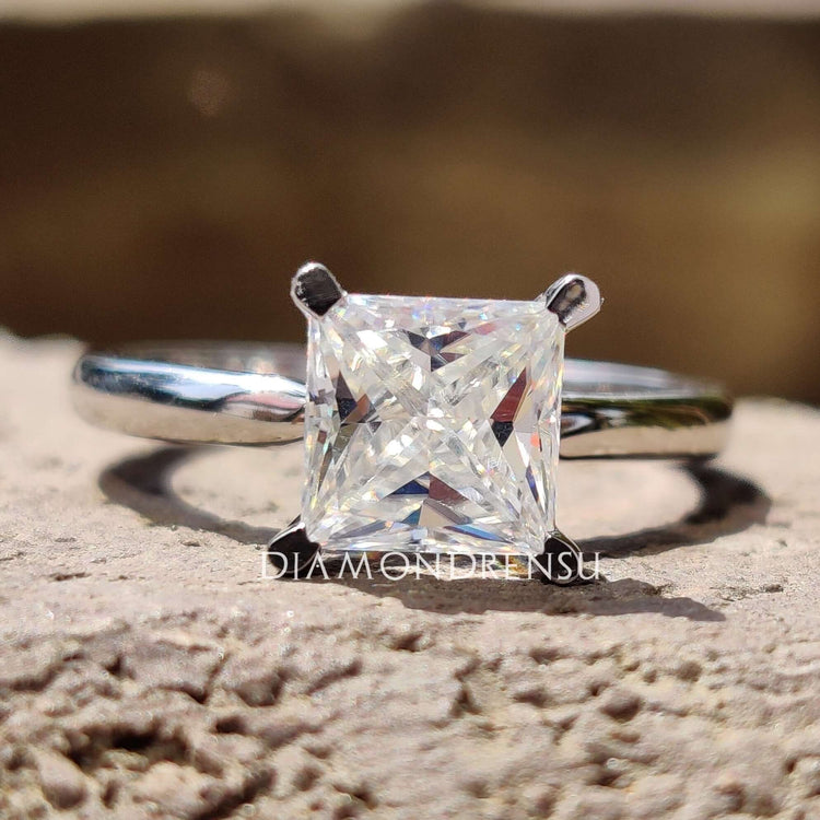 Princess cut moissanite engagement ring in white gold.
