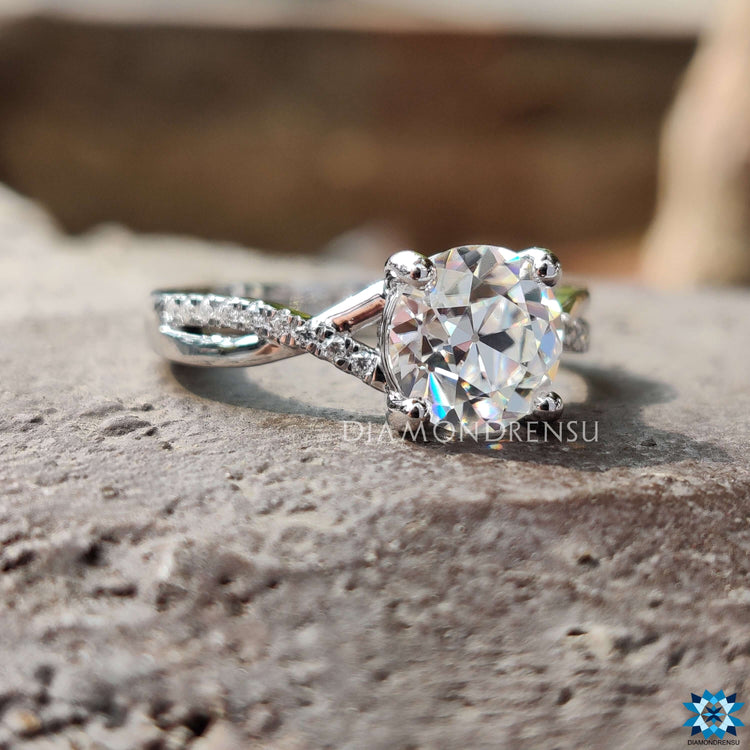 Handmade round cut moissanite ring with pave infinity band.