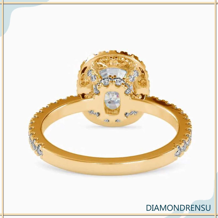 Cushion cut centre stone with 4 round prong setting.