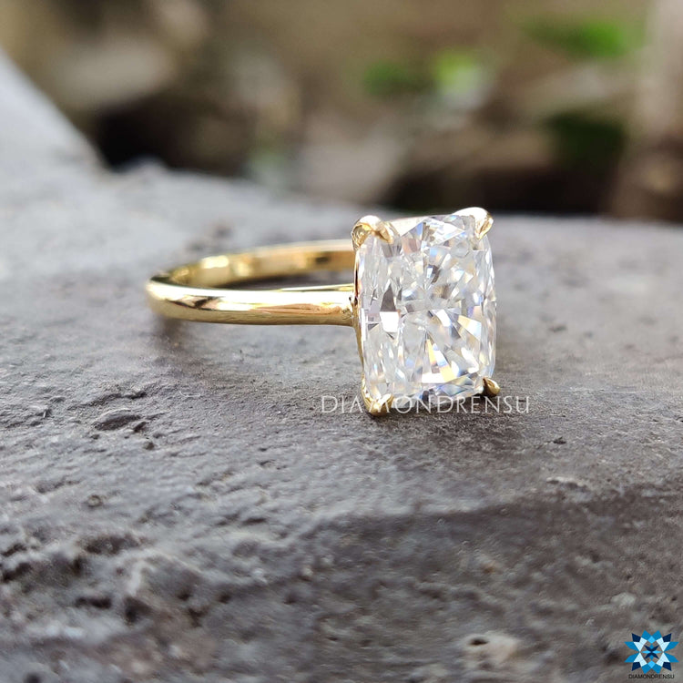 Custom solitaire moissanite ring crafted in yellow gold.