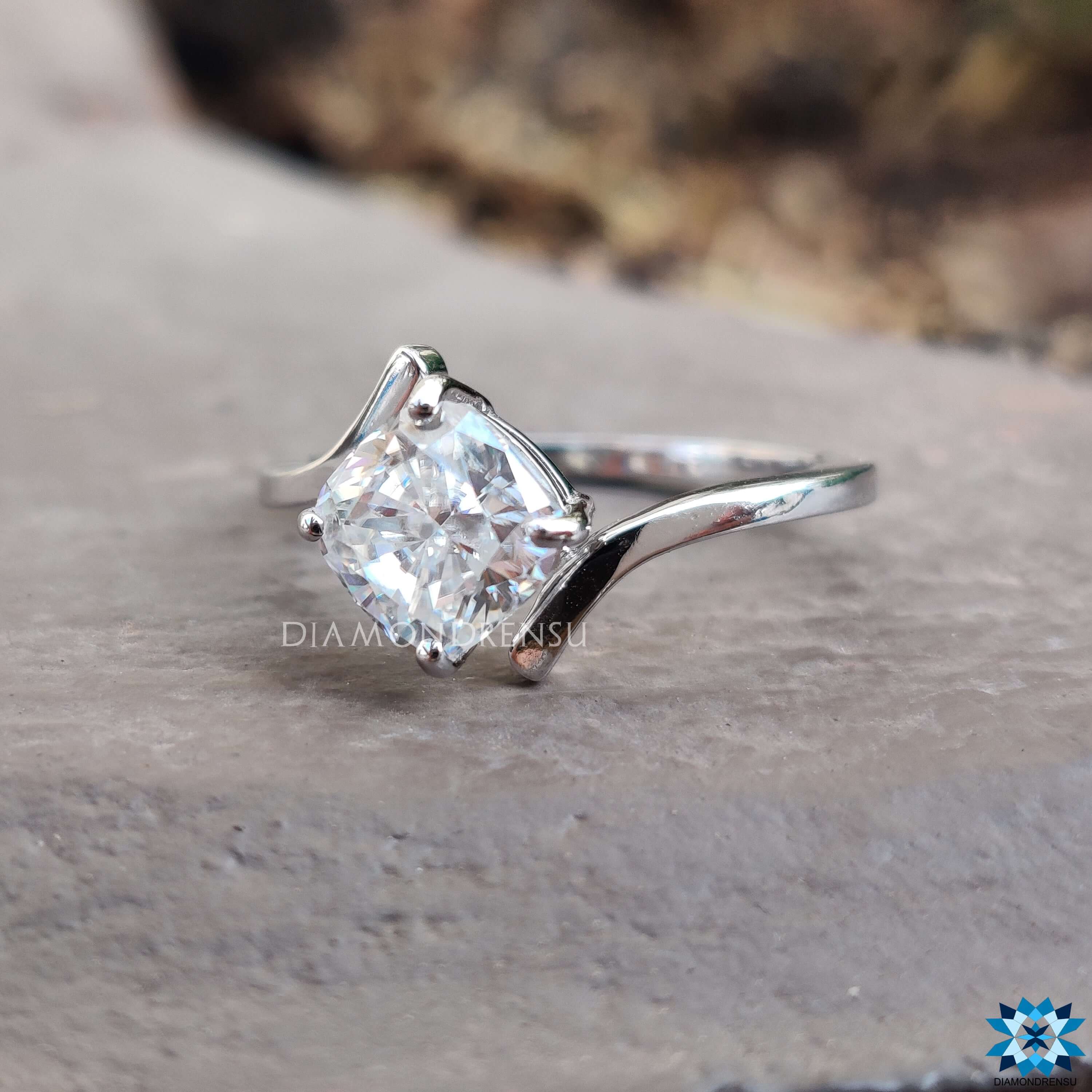 Bypass style engagement ring with cushion cut moissanite.