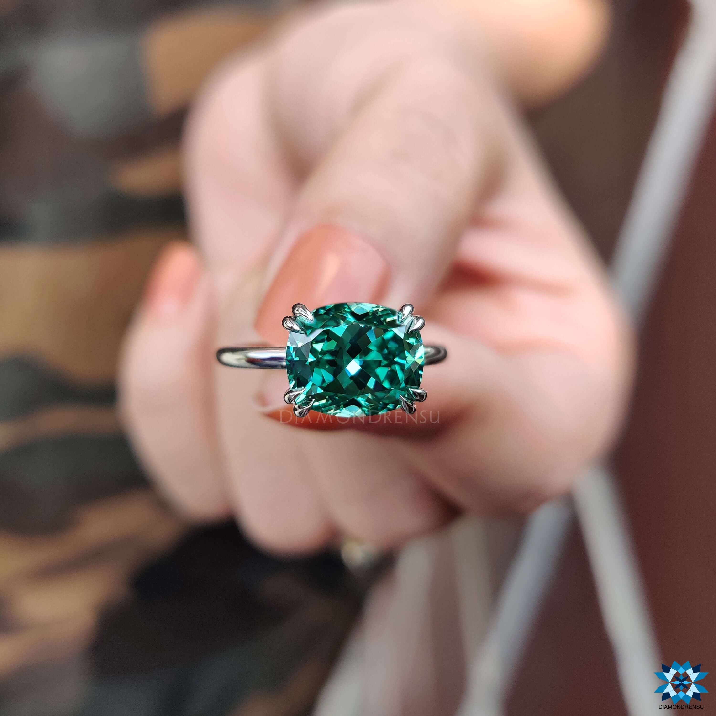 Cushion moissanite ring in east-west orientation.