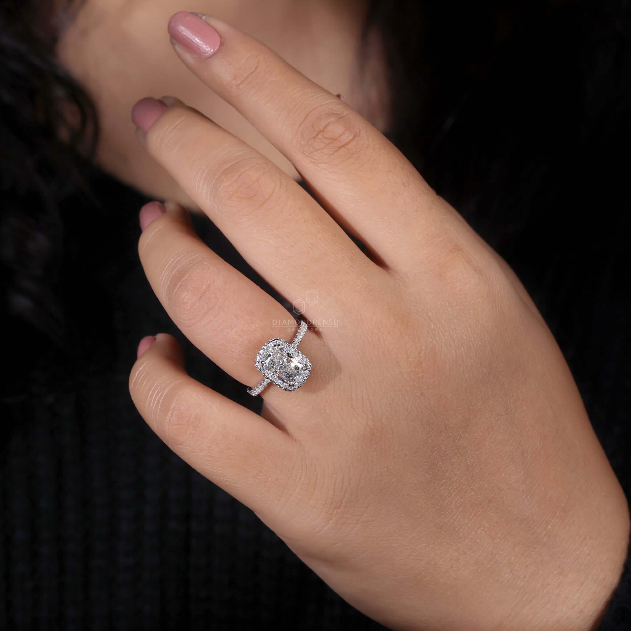 Elongated cushion cut diamond in a double claw prong pave setting for a sophisticated UK engagement ring.