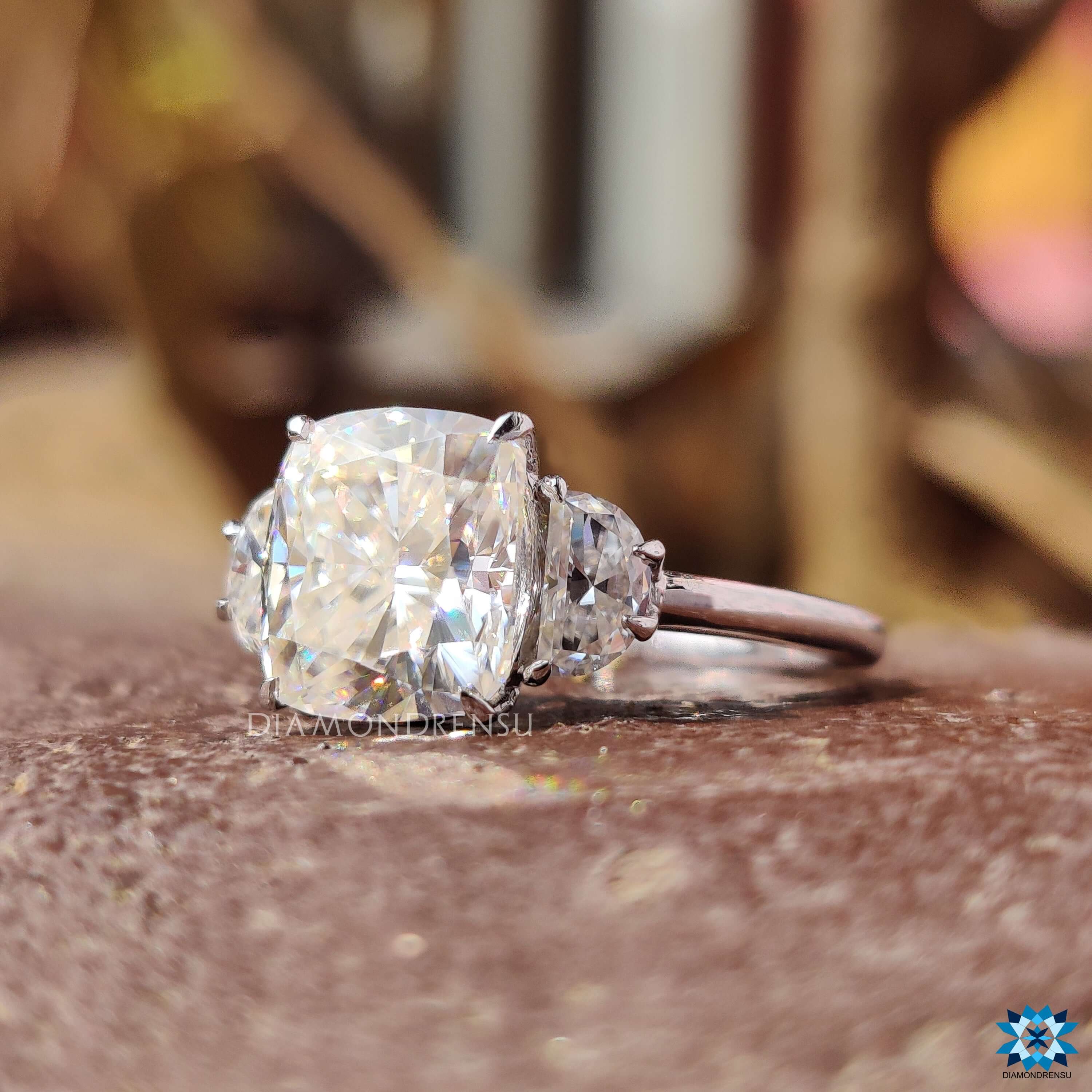 3 stone engagement ring featuring cushion and half moon cuts.