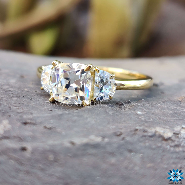 Custom engagement ring with cushion center and side stones.
