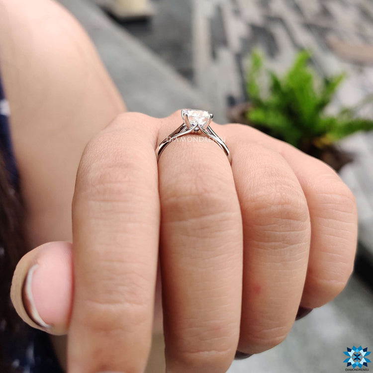 White gold solitaire engagement ring with Cushion Rensu cut moissanite.
