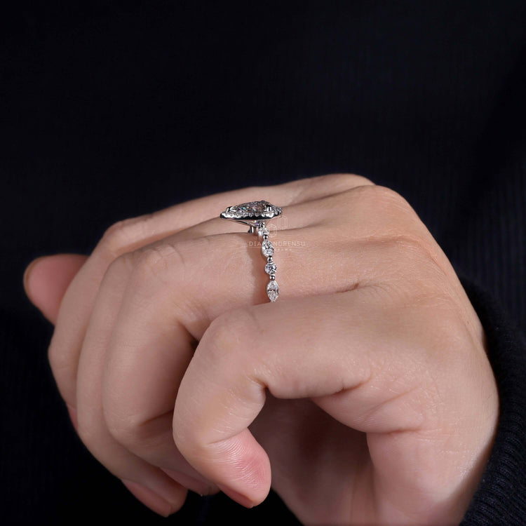 Pear diamond ring crafted with a halo ring ring and marquise and round side stones for added brilliance.
