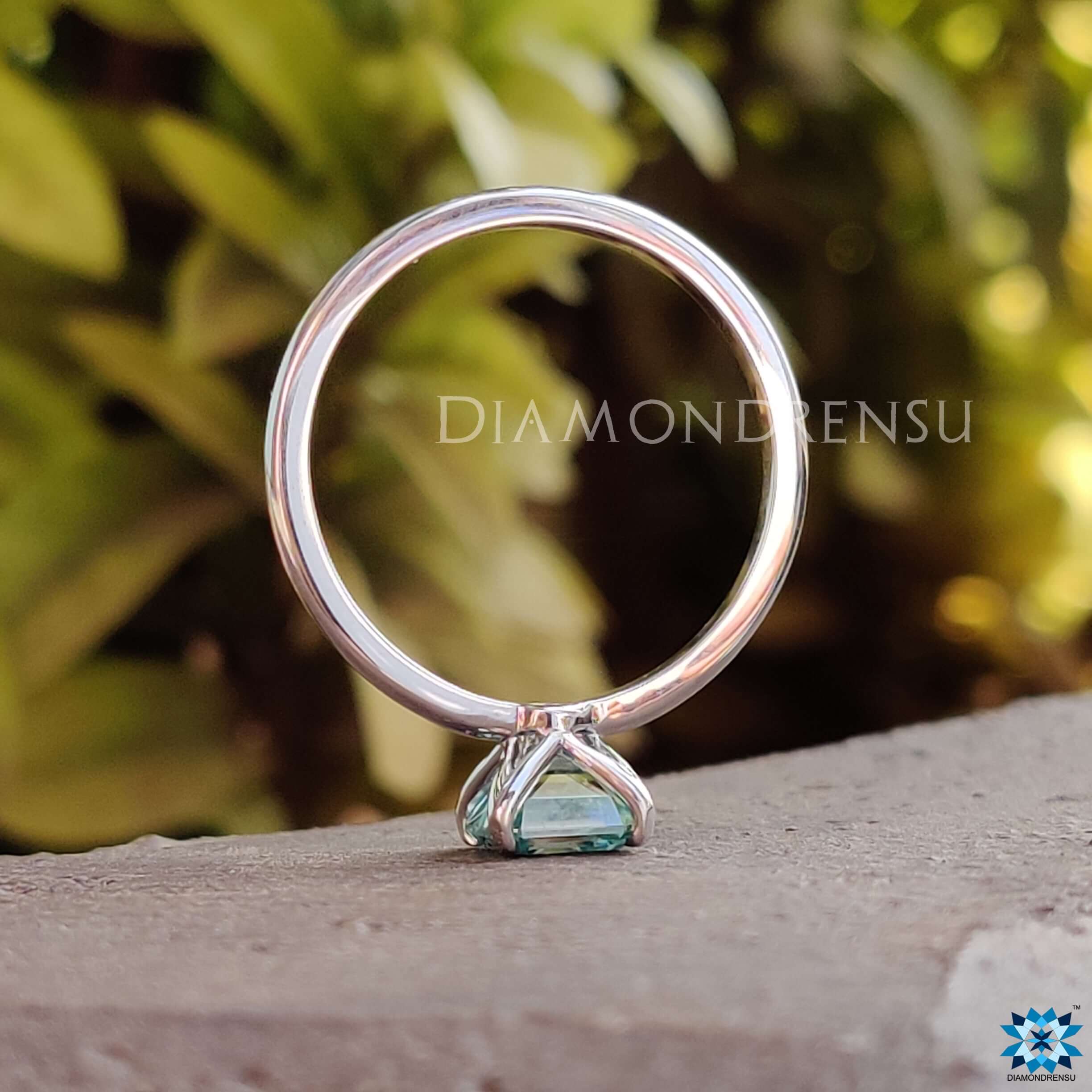 Custom engagement ring with an Asscher cut moissanite in cool tones.