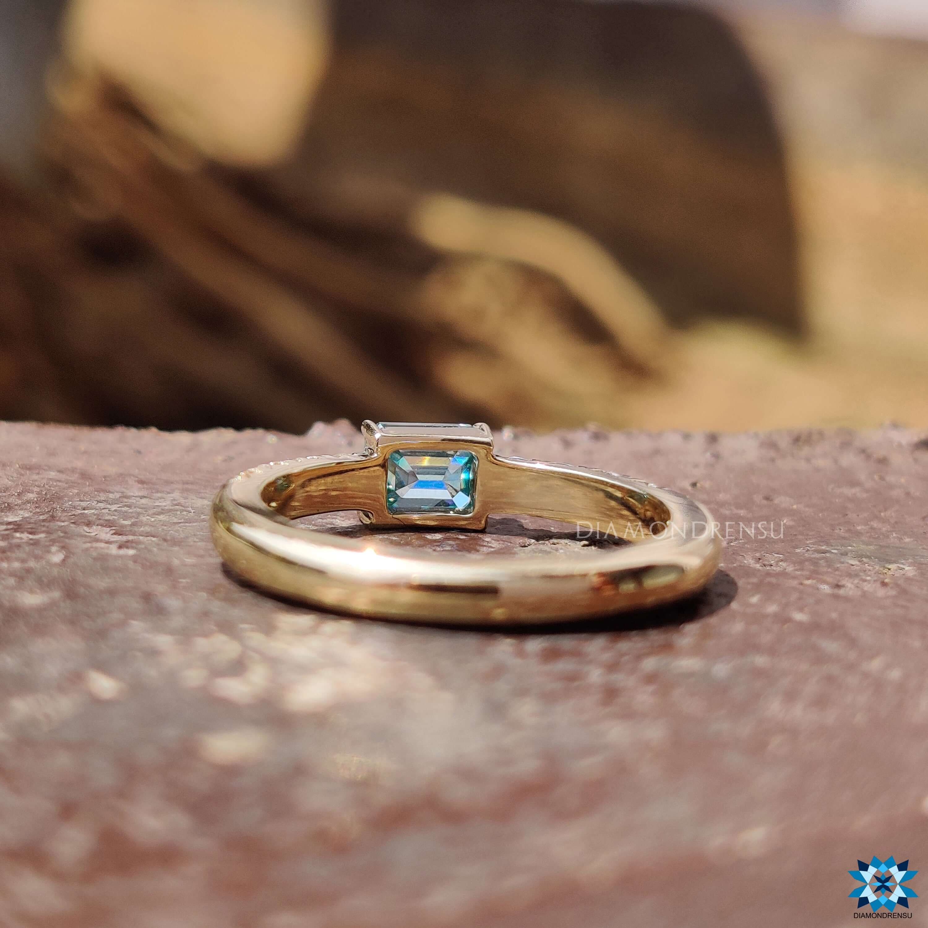Four claw prong yellow gold moissanite ring.