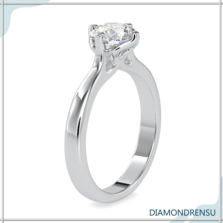 Designer ring with round diamond and custom tab prong.