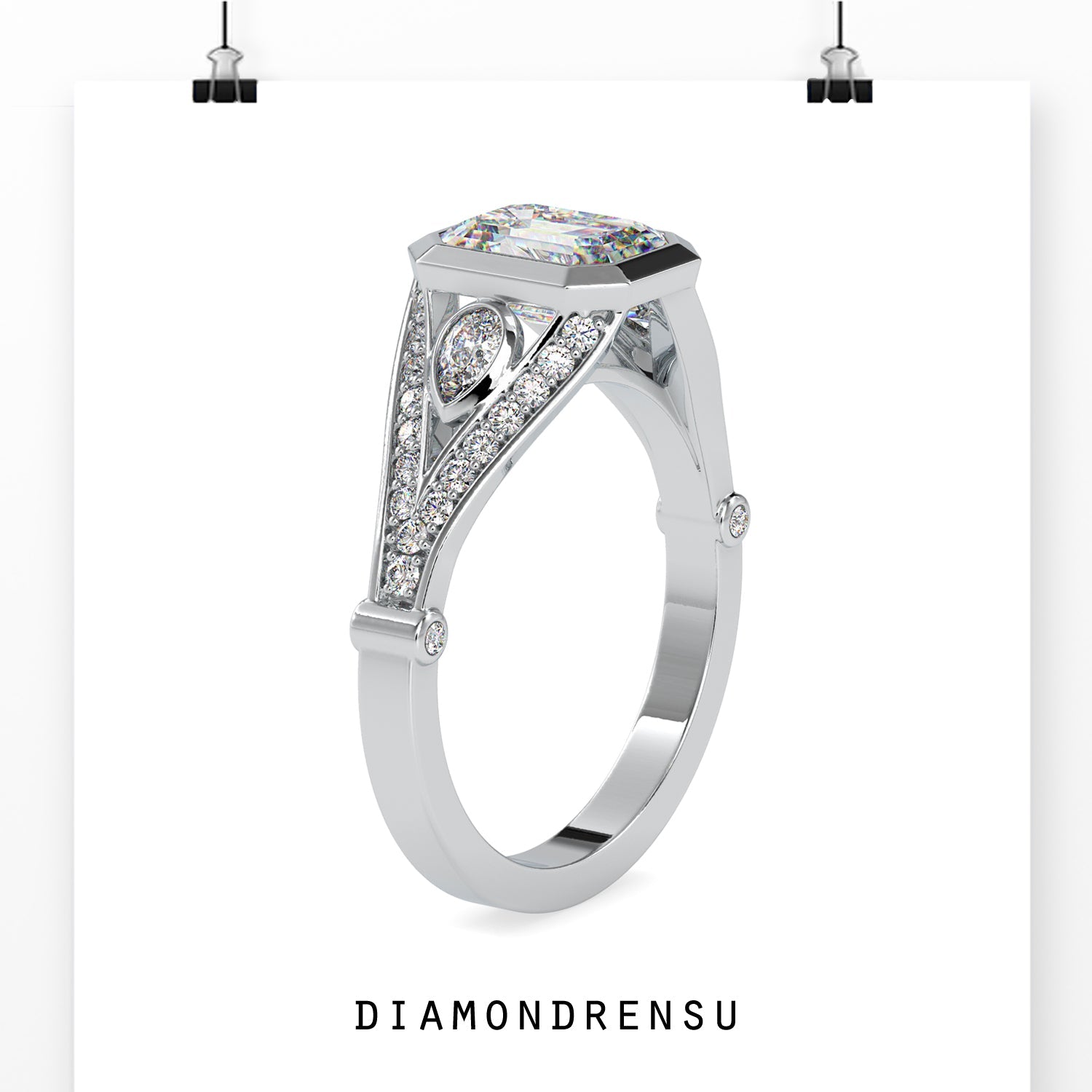 Pear side stone ring with emerald cut diamond in split shank.