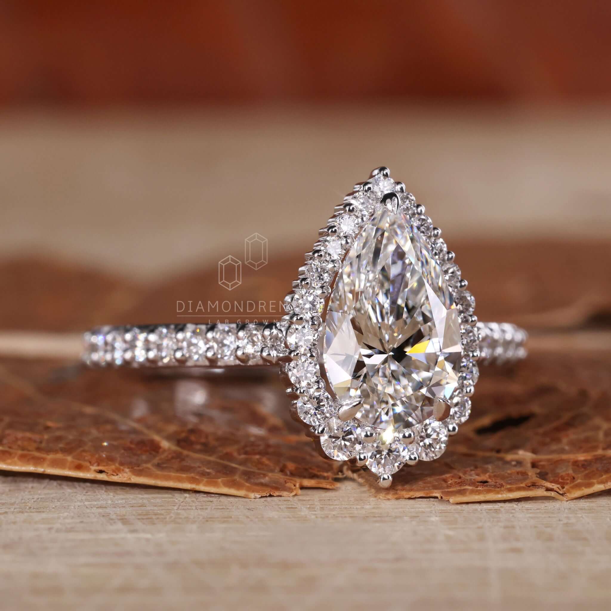 Halo pear shaped diamond ring with handmade jewellery detail.