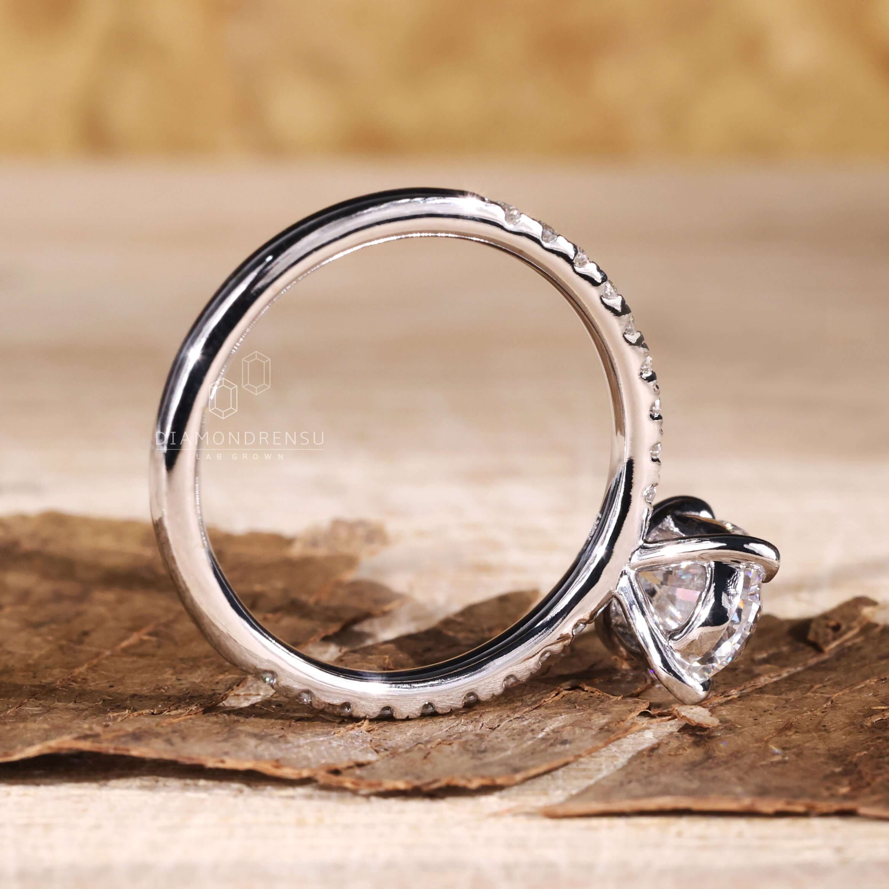 Pave diamonds in a unique uk engagement ring design that exudes charm.