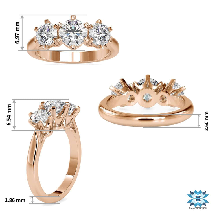 Yellow gold engagement ring featuring three round cut diamonds.