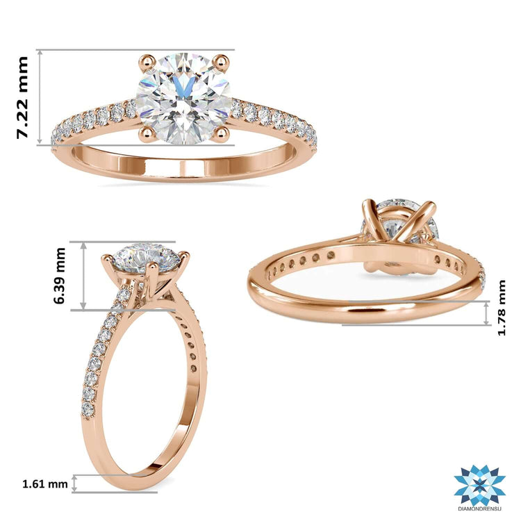 White gold engagement ring with round prong setting and pave band.