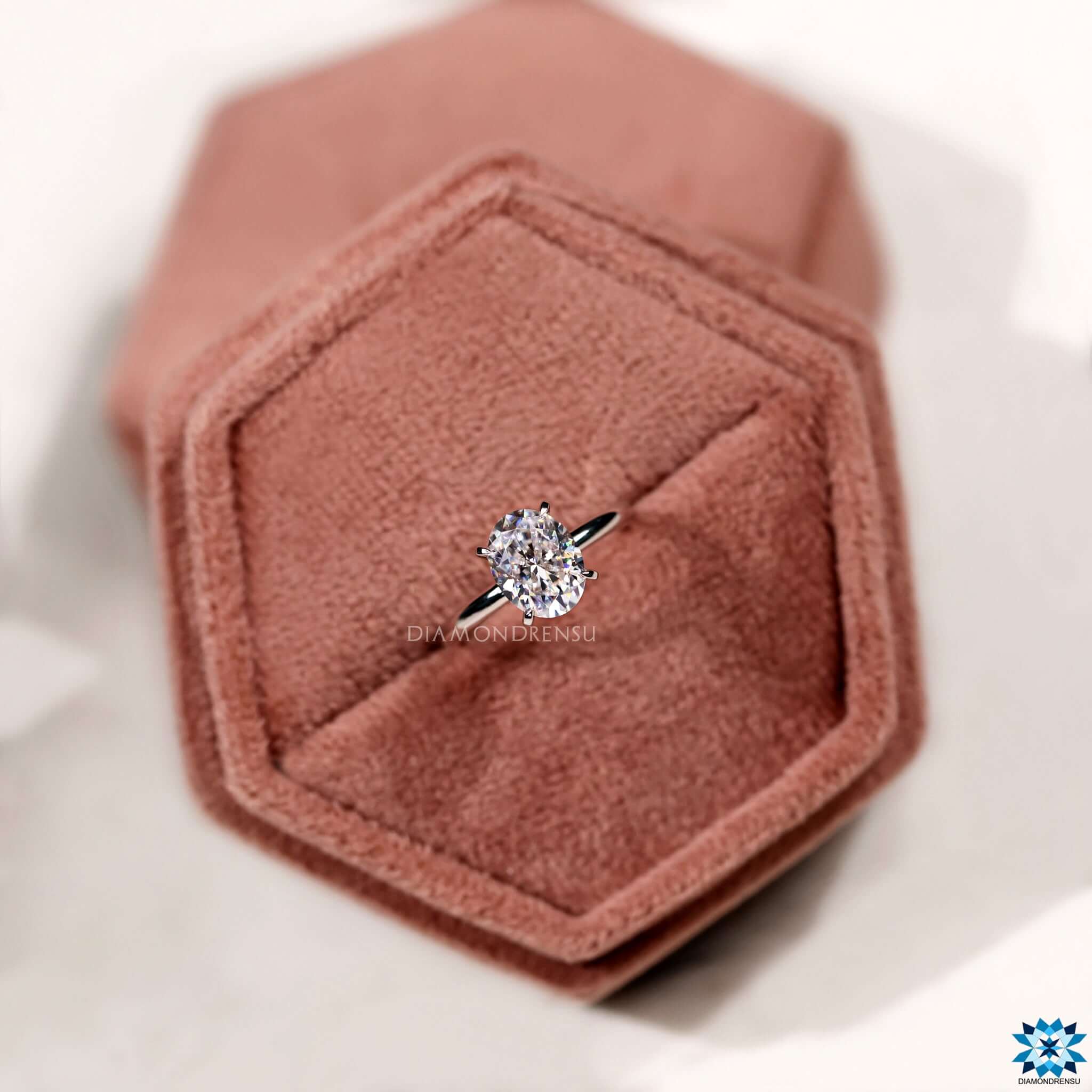 Four claw prong oval moissanite ring.
