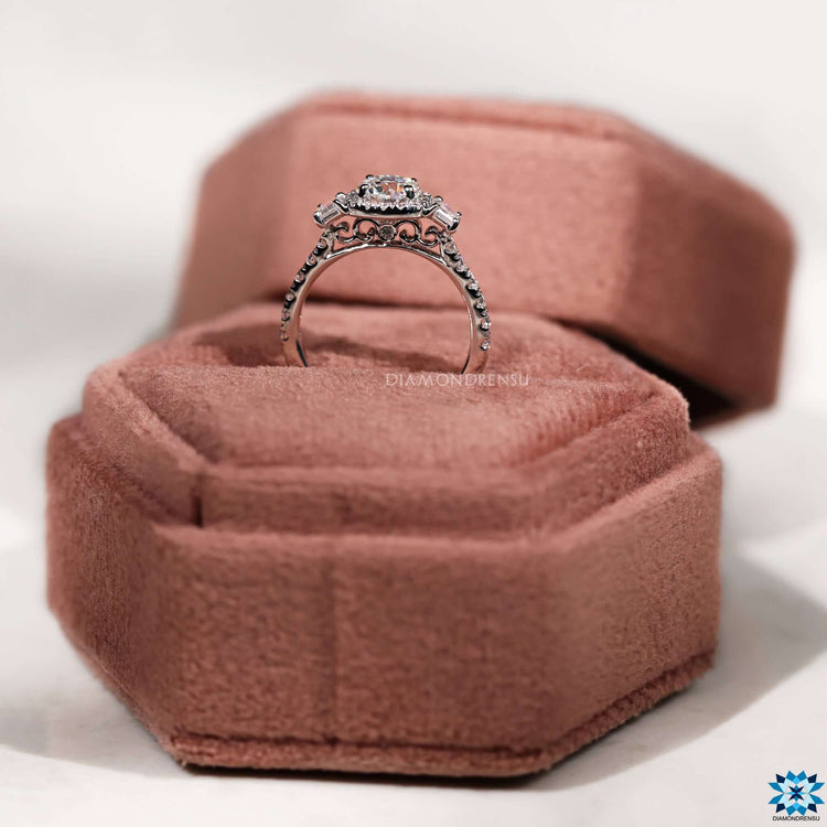 Round cut moissanite ring with trapezoid accents and 4 tab prong setting.