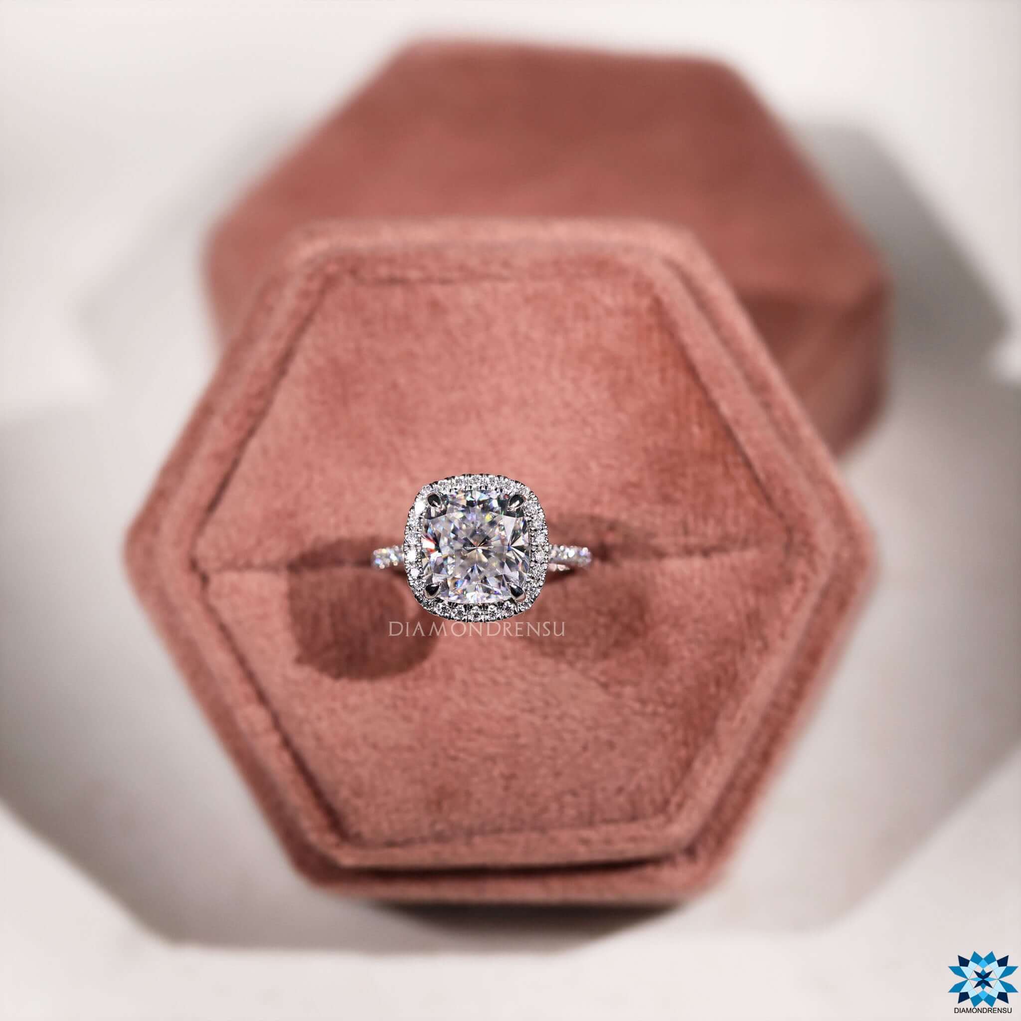 Pave setting ring with cushion cut center stone.